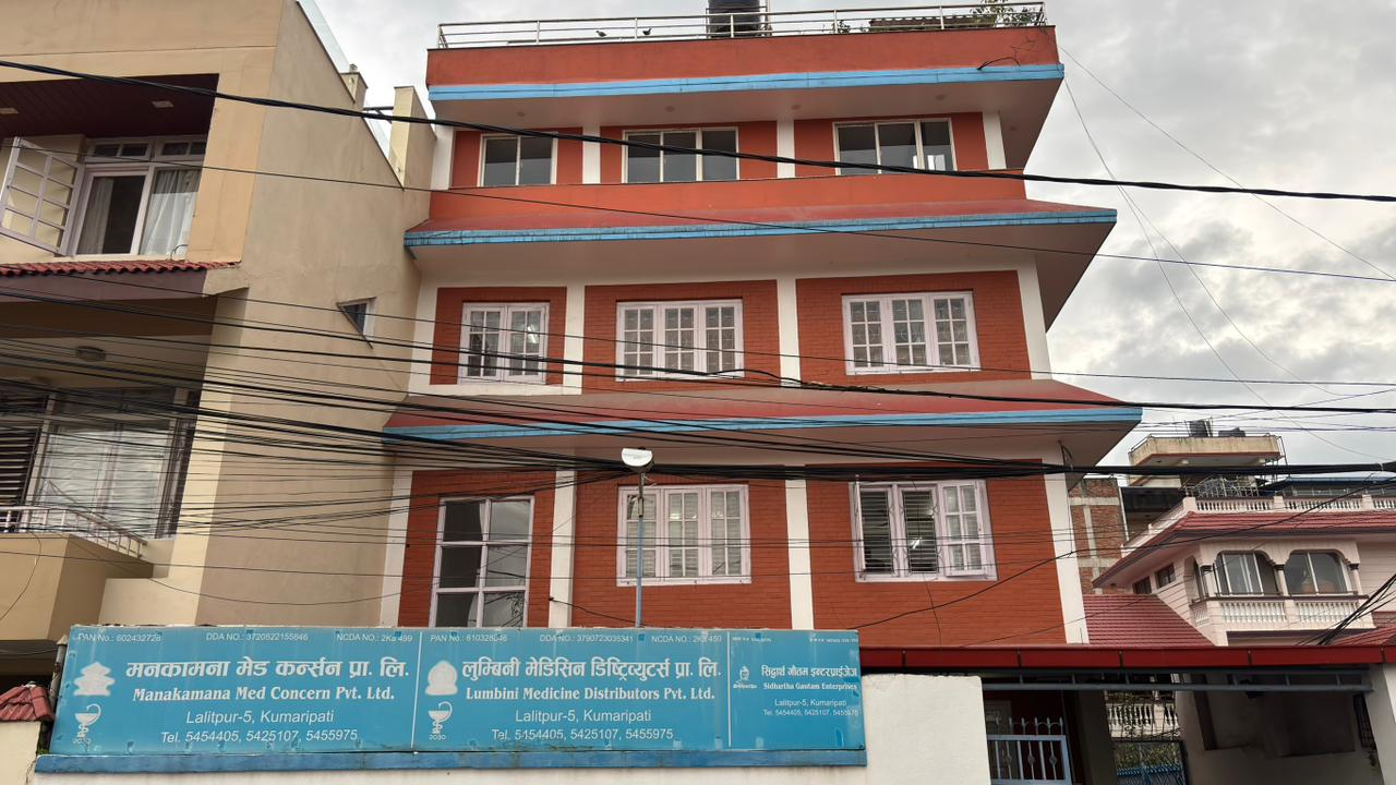 Manakamana Med Concern Pvt. Ltd. office building in Kumaripati, Lalitpur, with group company signs along the front wall.